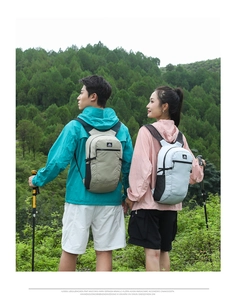 Outdoor backpacks detail showing mesh water bottle pockets and brand label in nature