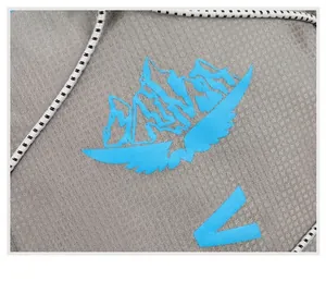 Macro detail of breathable grey mesh fabric with blue mountain logo and braided drawstring
