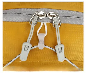 Detail of yellow ripstop fabric and smooth two-way metal zippers on a cycling backpack