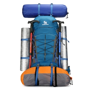 Blue high-capacity hiking backpack with exterior gear for outdoor camping and trekking