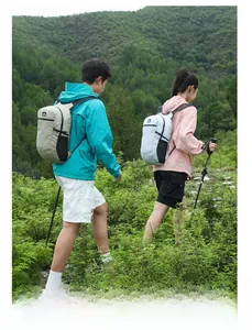 Outdoor hiking backpack in khaki and grey shown during trekking in a forest scenery