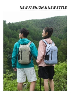 Rear view of lightweight green and blue hiking backpacks on models in a lush forest setting