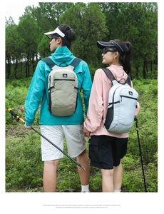 Rear view of two lightweight outdoor hiking backpacks in khaki and light green colors