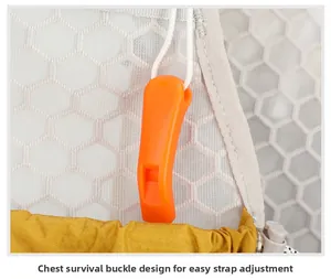Detail of the orange emergency whistle buckle on the breathable mesh running vest