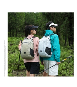Detail of grey outdoor backpack showing high-elastic side mesh pocket and nylon material