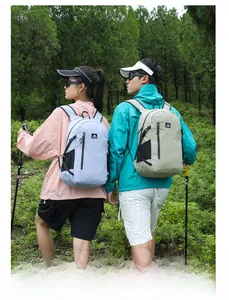 Lightweight hiking backpacks in blue and khaki shown in a scenic forest outdoor setting