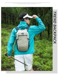 Outdoor light khaki backpack shown from behind on a male model in a lush green forest