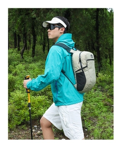 Outdoor hiking scene with high-capacity lightweight backpack and trekking poles in nature