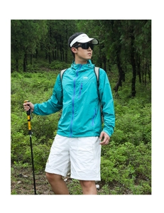 Outdoor detail of a lake green hiking jacket with purple contrast zipper and logo