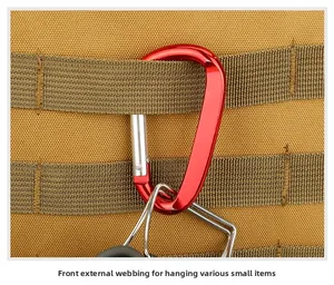 Dettaglio del moschettone a D rosso su fettuccia MOLLE beige per attacco attrezzatura outdoor