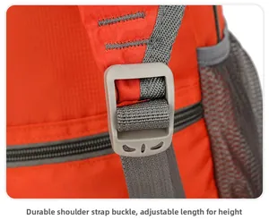 Detail of adjustable gray strap buckle on waterproof red foldable outdoor backpack