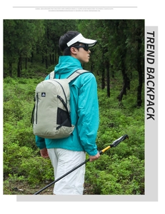 Outdoor light gray hiking backpack shown on model with water-resistant nylon fabric