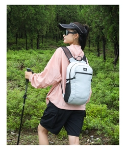Close-up of lightweight light grey hiking backpack with mesh water bottle pocket
