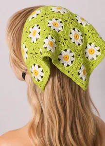 Detail of hand-crocheted green bandana featuring white daisies and elastic band