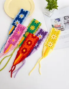 Detail view of handmade crochet flower headbands in colorful cotton knit patterns
