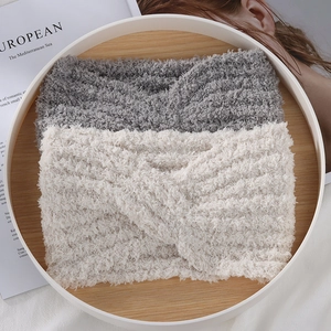 Close-up of thick sherpa fleece knotted headbands in grey and beige for winter warmth