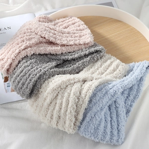 Cozy winter wide knitted headband set in four Morandi colors on a warm wooden tray