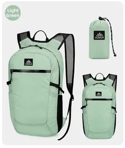 Macro view of mint green folding travel backpack showing stored pouch and mesh straps