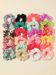 Flat lay of 24-piece assorted satin and velvet hair scrunchies in colorful patterns