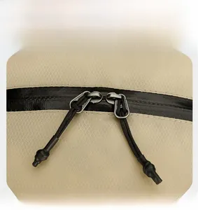 Macro view of sturdy two-way waterproof zippers on khaki ripstop outdoor backpack