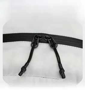 Close-up of waterproof dual-way zippers and diamond pattern fabric on outdoor backpack