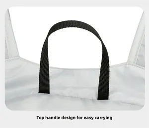 Close-up of the black nylon top handle on the white lightweight hiking backpack