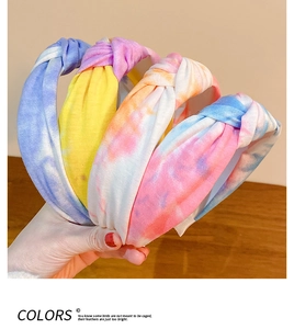 Detail of four colorful tie-dye twist knot headbands in blue, purple, and orange tones
