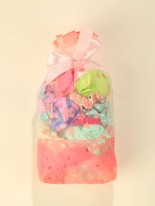 Colorful scrunchies in translucent gift bag with pink cherry blossom pattern and ribbon bow