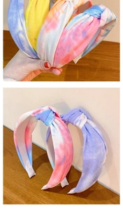 Detailed view of colorful tie-dye knotted headband with soft cotton texture and fabric finish