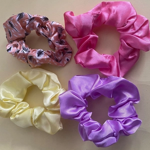 4-pack satin scrunchie set featuring pink feather print, purple, and yellow colors