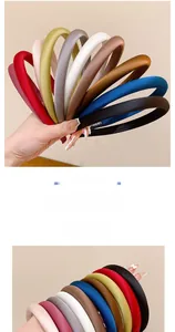 Detail showing high-quality satin fabric texture and handmade label on slim headbands