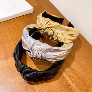 Three-piece set of stylish metallic knotted wide headbands in gold, silver, and black finish