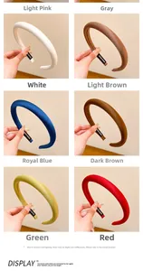Detail of silk satin padded headbands showing assorted colors with Hand Made label details