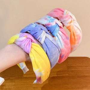 Set of four colorful tie-dye knotted headbands in yellow, purple, blue and orange shades