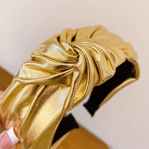 Chic knotted gold metallic fabric headband with stylish pleated texture for women