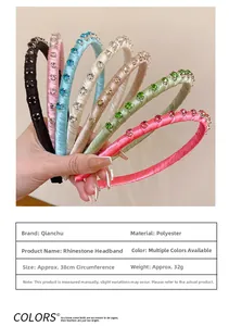 Detail view of colorful rhinestones on a slim fabric headband with dimensions