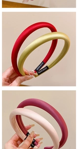 Close-up of thick satin sponge headbands with handmade tags in vibrant colors