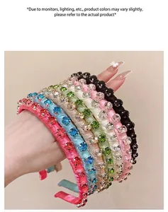 Detail view of colorful rhinestone-encrusted satin headbands in pink, blue, and green