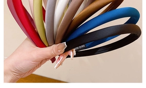 Macro shot of colorful satin padded headbands in various elegant shades like red and navy