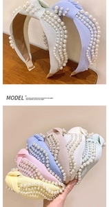Detail eines gedrehten Perlenstirnbands mit eleganten Pastellstoffen und Handperlen