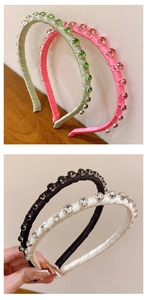 Detail view of colorful rhinestone headbands in green, pink, black, and white fabric