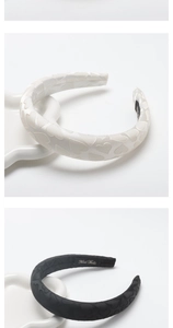 Detail of satin padded headbands with embossed hearts showing black and white options