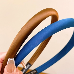 Minimalist satin padded headband in deep brown and peacock blue with handmade label