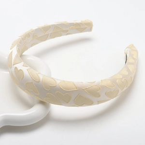 Padded cream satin headband with 3D heart texture and elegant aesthetic design