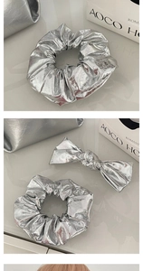 Detail of silver metallic PU leather scrunchie and bow hair clip with glossy texture