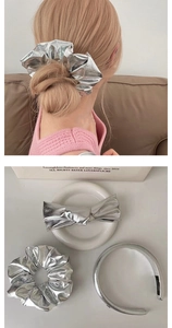 Close-up of metallic silver PU leather scrunchie, bow clip and headband set for women