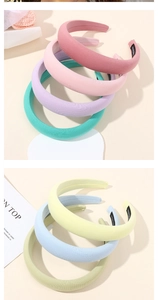 Detail of macaron-colored sponge headbands with handmade labels and soft fabric finish