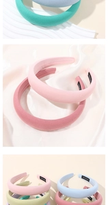 Detail of padded macaron hairbands with handmade woven labels and premium fabric texture