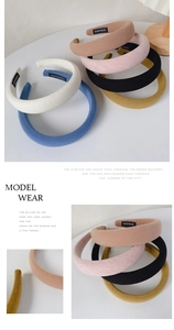Detailed view of handmade waffle knit headbands in various colors with thick soft texture