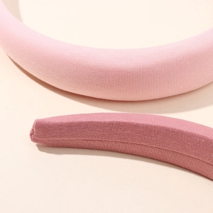 Pink ribbed fabric padded headbands for women featuring stylish high-top minimalist design